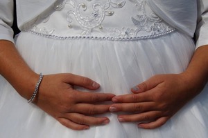 Hands on bride stomach