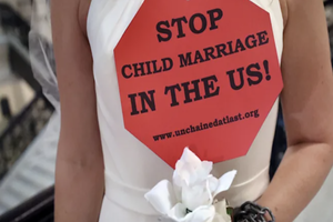 Stop Child Marriage sign held by bride