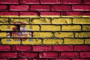 Spain flag painted over brick wall