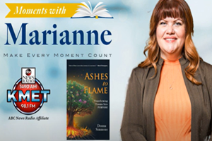 A woman with read hair smiles next to the cover of her book, called Ashes to Flame, which has a glowing tree on the cover