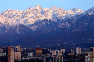 a city skyline with mountains rising in the background