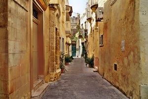 an alleyway of light tan stone in Malta